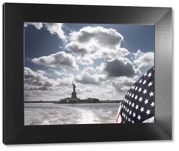 View of Statue of Liberty from rear of bot with Stars and Stripes flag
