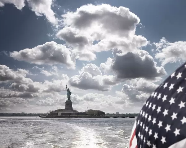 View of Statue of Liberty from rear of bot with Stars and Stripes flag