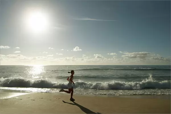 Early morning female runner, Bondi beach, Sydney, New South Wales, Australia, Pacific