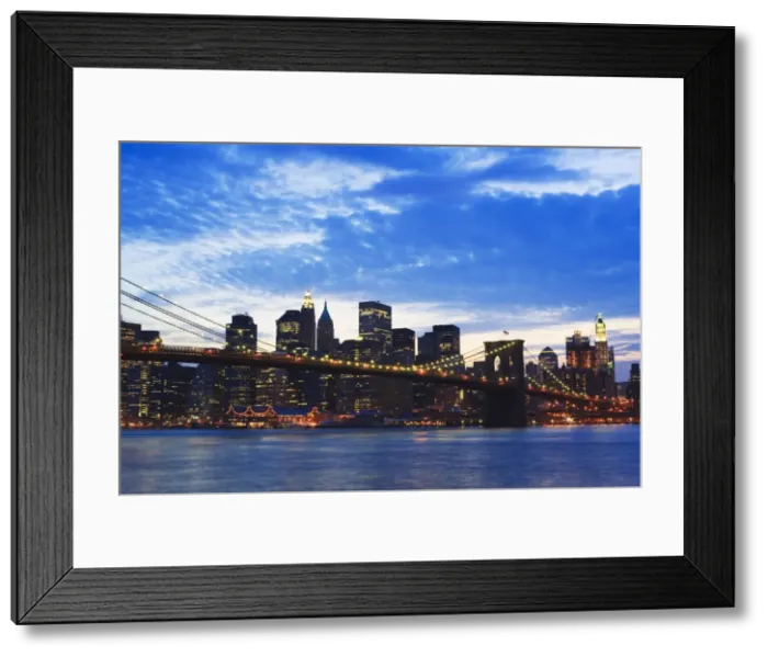 Framed Print : Brooklyn Bridge spanning the East River and the Lower Manhattan skyline at dusk Framed Print : Brooklyn Bridge spanning the East River and the Lower Manhattan skyline at dusk