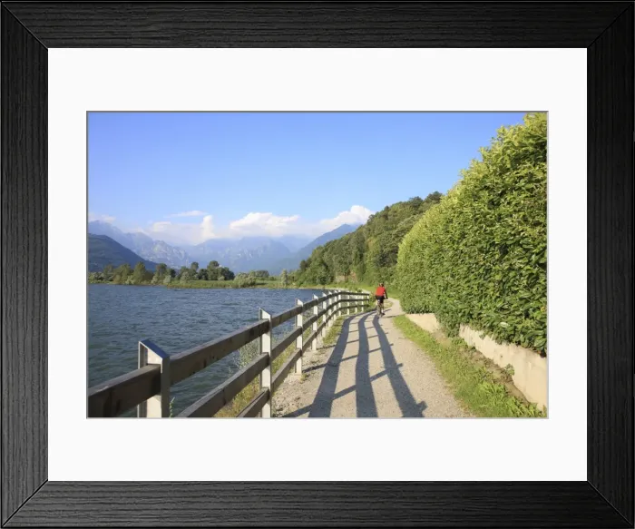 Framed Print : Man bikes along path at lakes edge, Lake Como, Italian Lakes, Lombardy