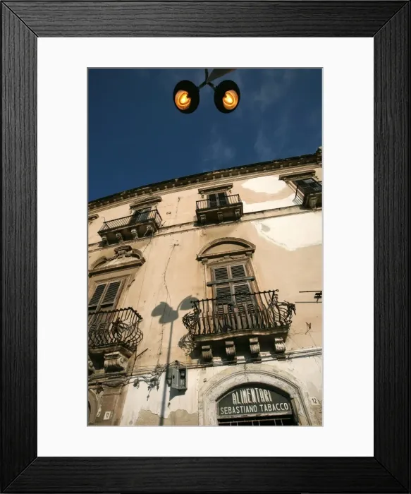 Framed Print : Street lights overlooking a grocers store in the narrow streets of the old city of Ortigia Framed Print : Street lights overlooking a grocers store in the narrow streets of the old city of Ortigia