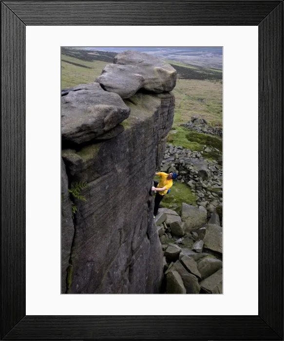 Framed Print : Climber makes a solo ascent of one of the thousands of classic outcrop climbs on the popular cliff of Stanage Edge, near Hathersage, Peak District, Derbyshire, England, United