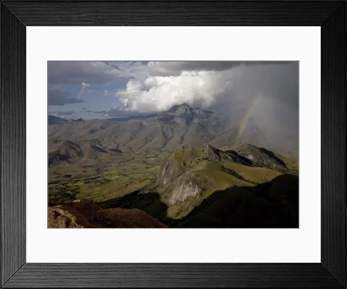 Framed Print : A rainbow appears looking east across the granite mountains of the Andringitra National Park Framed Print : A rainbow appears looking east across the granite mountains of the Andringitra National Park