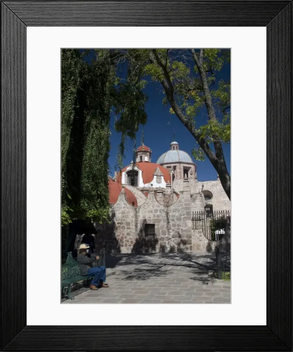Framed Print : Local man resting on a park bench with Iglesia del Carmen in background