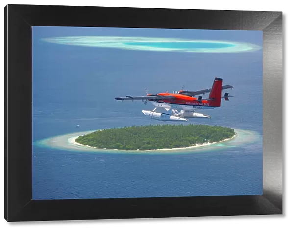 Maldivian Air Taxi flying above island, Maldives, Indian Ocean, Asia