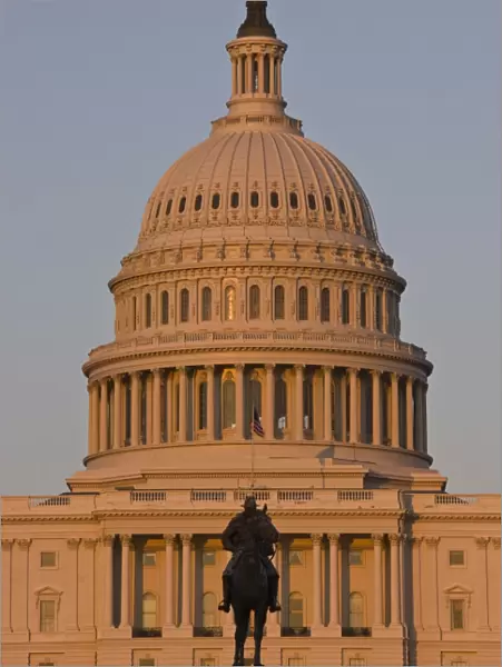 Statue in front of the dome of the U. S. Capitol Building, evening light, Washington D
