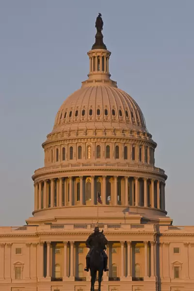 Statue in front of the dome of the U. S. Capitol Building, evening light, Washington D