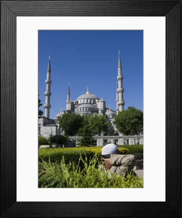 Framed Print : Turkish man with traditional headware relaxing in Sultanahmet Square in front of the Blue Mosque Framed Print : Turkish man with traditional headware relaxing in Sultanahmet Square in front of the Blue Mosque