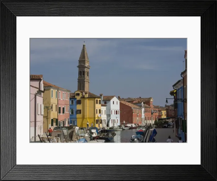 Framed Print : A canal with pastel painted houses and the leaning tower of San Martino Framed Print : A canal with pastel painted houses and the leaning tower of San Martino
