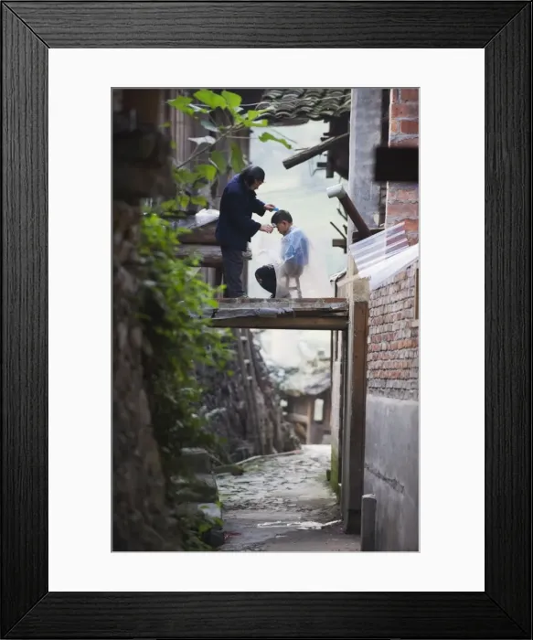 Framed Print : An outdoor barber cutting a boys hair in Langde village, Guizhou Province Framed Print : An outdoor barber cutting a boys hair in Langde village, Guizhou Province