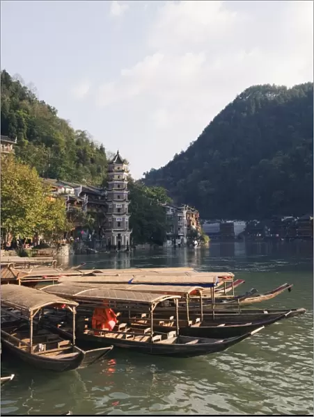 Boats tied up on a river in the old town of Fenghuang, Hunan Province, China, Asia