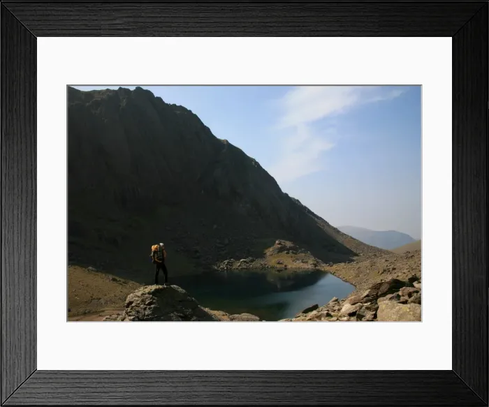 Framed Print : A hiker looks across the still waters of Llyn Du r Arddu, one of Waless highest lakes Framed Print : A hiker looks across the still waters of Llyn Du r Arddu, one of Waless highest lakes