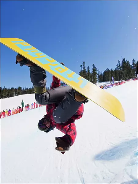 A snowboarder jumping at Telus Half Pipe competition 2009