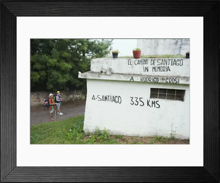 Framed Print : Hiker pilgrims looking at a distance marker to Santiago de Compostela, on the Camino de Santiago Framed Print : Hiker pilgrims looking at a distance marker to Santiago de Compostela, on the Camino de Santiago