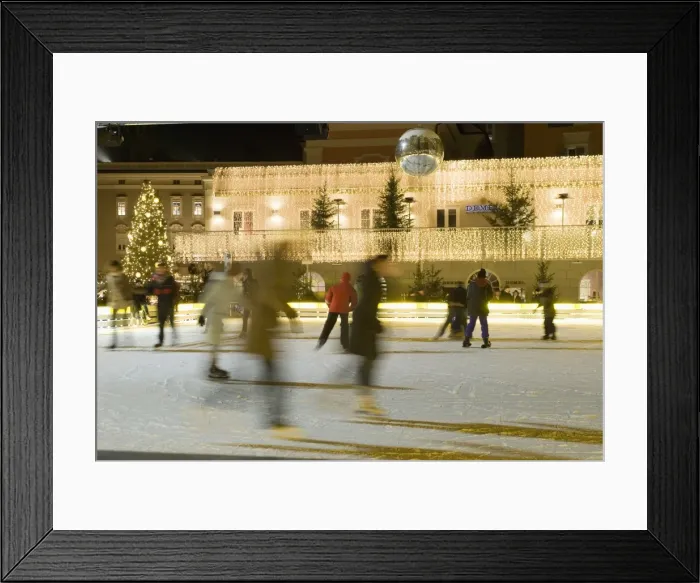 Framed Print : Ice skating at night on ice rink at Mozartplatz square, Salzburg, Austria, Europe Framed Print : Ice skating at night on ice rink at Mozartplatz square, Salzburg, Austria, Europe