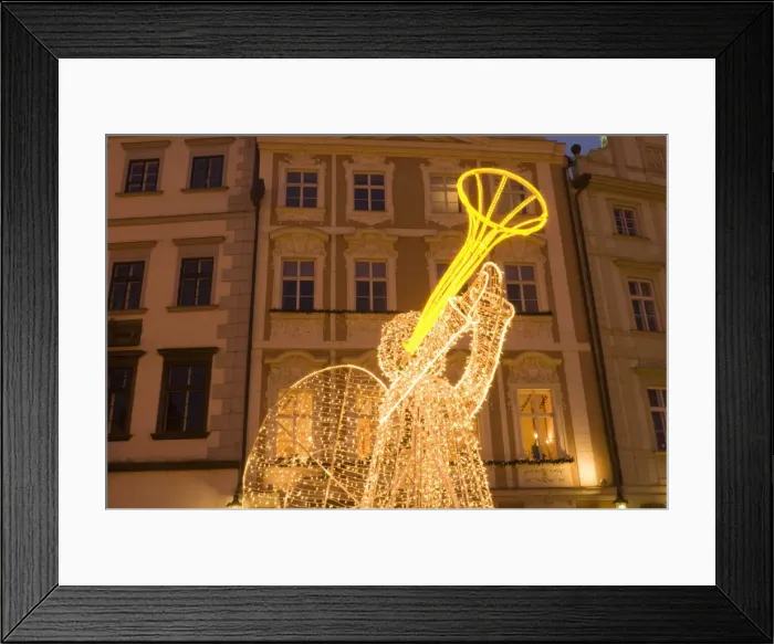 Framed Print : Illuminated angel against Baroque house facades, part of Christmas decorations Framed Print : Illuminated angel against Baroque house facades, part of Christmas decorations