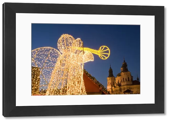 Glowing angel, part of Christmas decoration at Staromestske (Old Town Square) with Baroque St