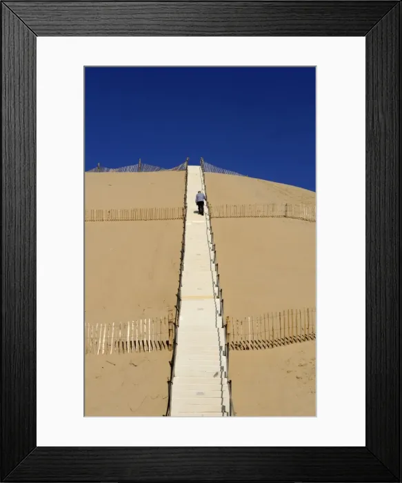 Framed Print : Man climbing steps leading up to Dunes du Pyla, Bay of Arcachon, Cote d Argent Framed Print : Man climbing steps leading up to Dunes du Pyla, Bay of Arcachon, Cote d Argent