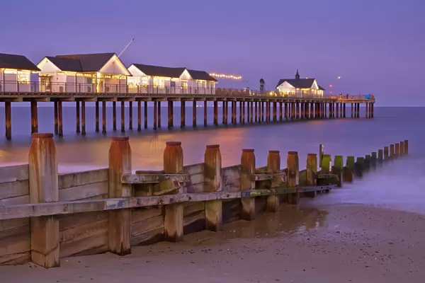 Southwold pier and wooden groyne at sunset, Southwold, Suffolk, England