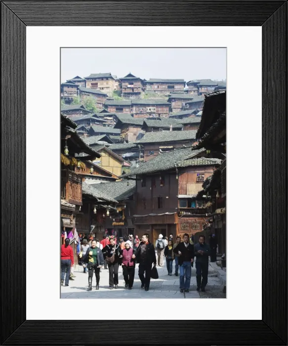 Framed Print : Tourists walking by wooden houses on the old streets of Xijiang, Guizhou Province Framed Print : Tourists walking by wooden houses on the old streets of Xijiang, Guizhou Province