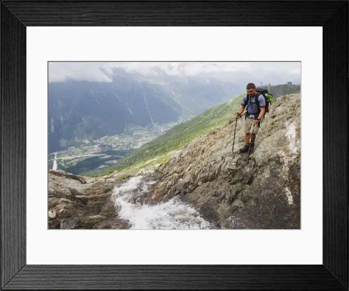Framed Print : Hiker crossing a stream above Chamonix Valley, Rhone Alps, France, Europe
