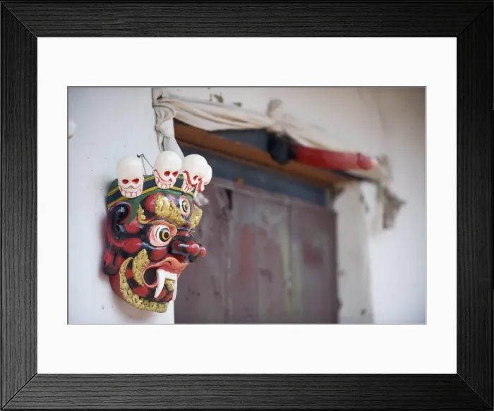 Framed Print : Mask and phallus hanging on a door to protect its occupants, near the temple of the Divine Madman Framed Print : Mask and phallus hanging on a door to protect its occupants, near the temple of the Divine Madman