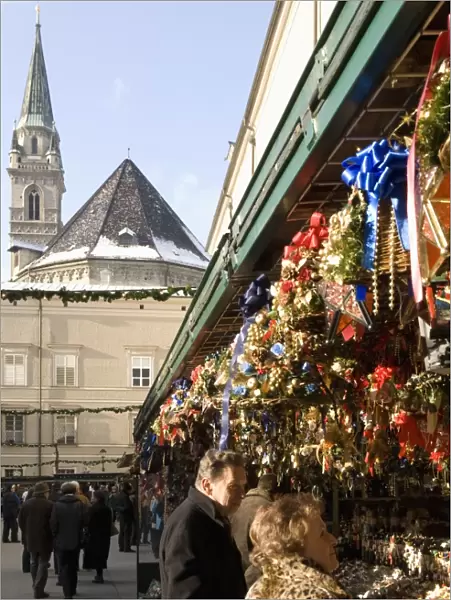 Stall selling Christmas decorations with towers of Franziskanerkirche churchbehind