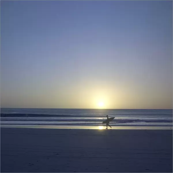 Silhouette of surfer walking on Avellanas Beach, Nicoya Peninsula, Costa Rica