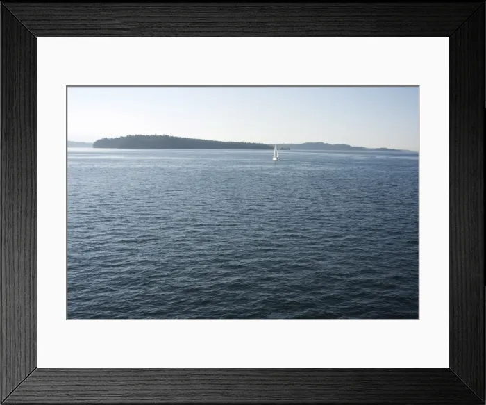 Framed Print : Sailboat on the Puget Sound passes Blake Island, Washington State, United States of America Framed Print : Sailboat on the Puget Sound passes Blake Island, Washington State, United States of America