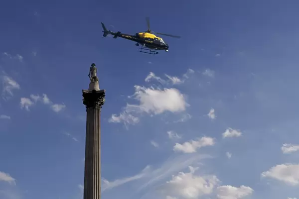 Nelsons Column and police helicopter, London, England, United Kingdom, Europe