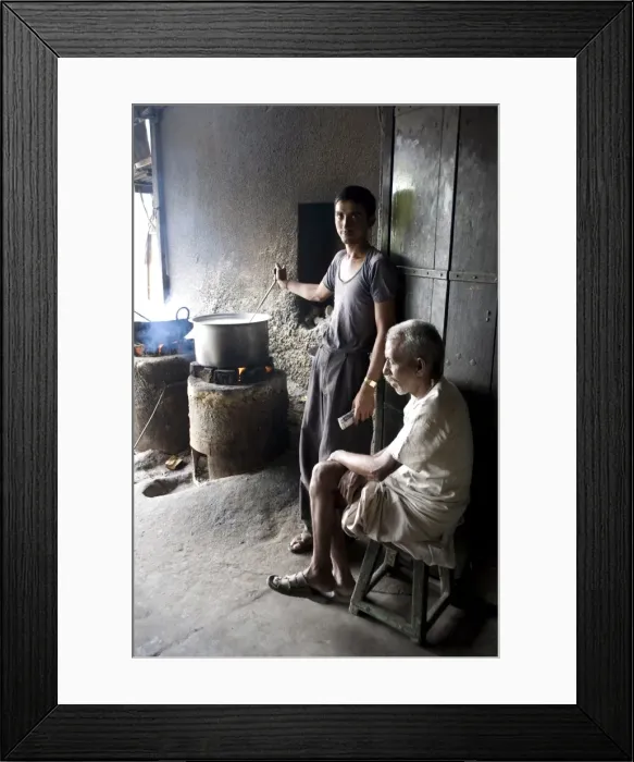 Framed Print : Young man stirring milk for chai, with blind man sitting beside him, roadside chai stall Framed Print : Young man stirring milk for chai, with blind man sitting beside him, roadside chai stall
