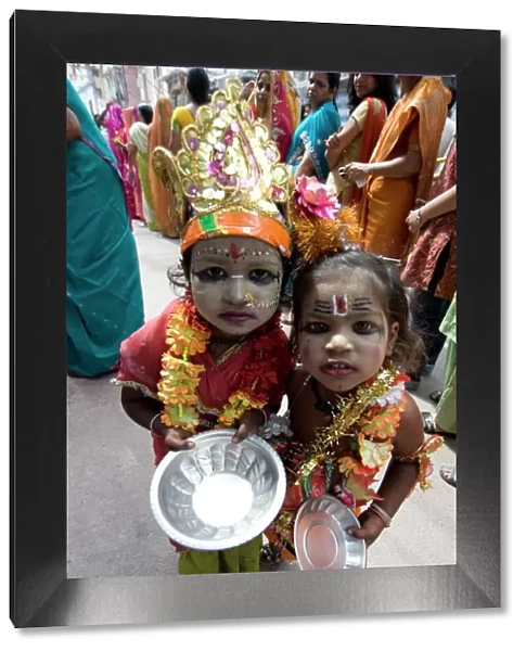 Two street children dressed in the style of Krishna at Diwali festival time