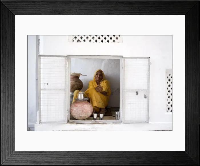 Framed Print : Woman offering drinking water to devotees at Jagdish temple, Udaipur, Rajasthan