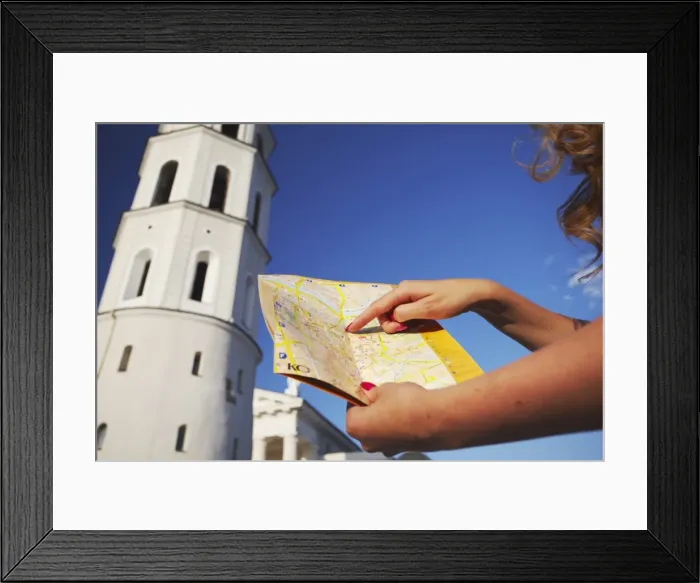 Framed Print : Woman standing outside Vilnius Cathedral Belfry with map, Vilnius, Lithuania Framed Print : Woman standing outside Vilnius Cathedral Belfry with map, Vilnius, Lithuania