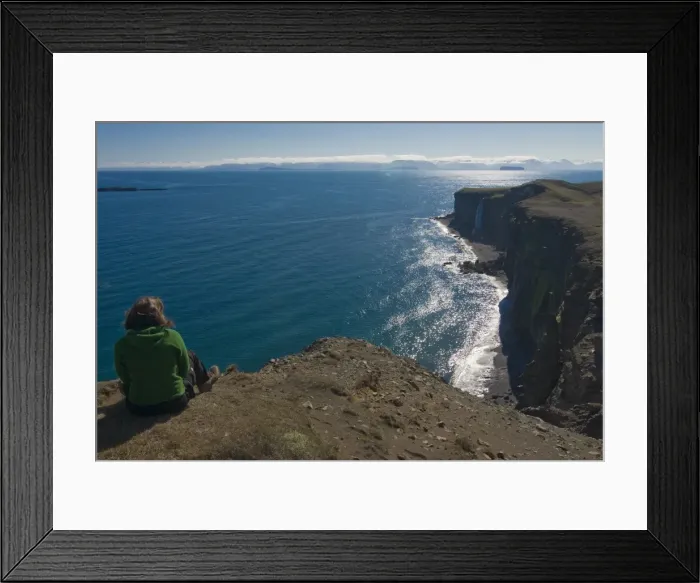 Framed Print : Woman sitting above the steep coast with cliffs, Vatnsnes Peninsula, Iceland Framed Print : Woman sitting above the steep coast with cliffs, Vatnsnes Peninsula, Iceland