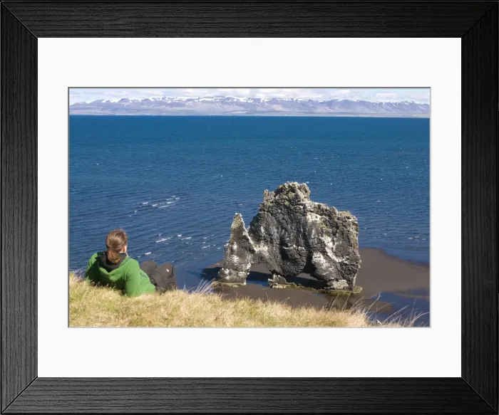 Framed Print : Tourist relaxing at the famous Hvitserkur rock formation, Vatnsnes Peninsula Framed Print : Tourist relaxing at the famous Hvitserkur rock formation, Vatnsnes Peninsula