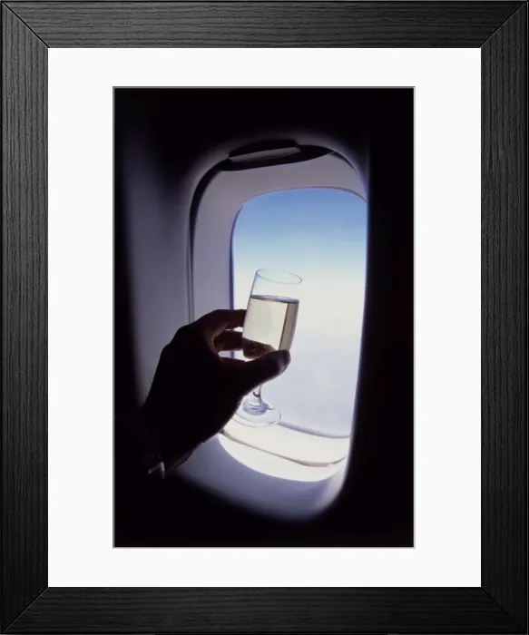 Framed Print : Glass of champagne at 30000 feet and aircraft window Framed Print : Glass of champagne at 30000 feet and aircraft window
