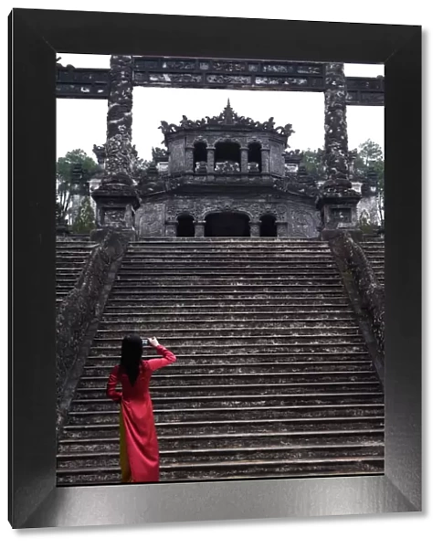Vietnamese schoolgirl taking picture of Khai Dinhs Tomb, Hue, Vietnam