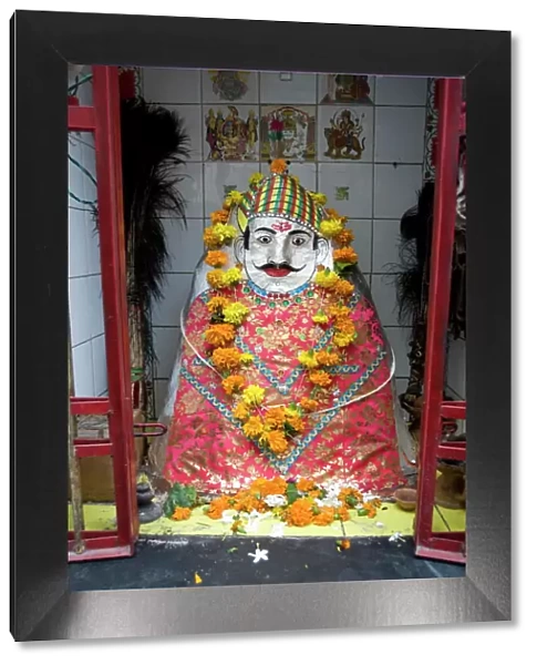 Hindu street shrine, decorated with marigold mala (garlands) for Diwali festival