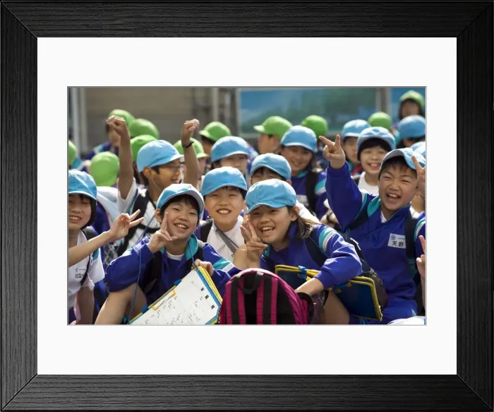 Framed Print : Group of smiling Japanese elementary school children wearing blue and green caps Framed Print : Group of smiling Japanese elementary school children wearing blue and green caps