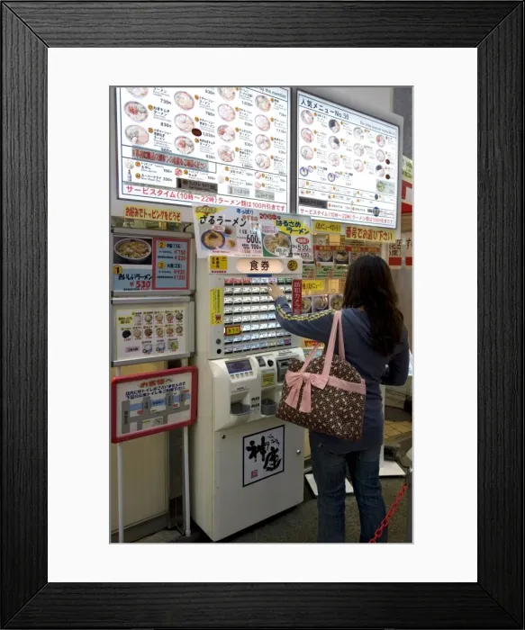 Framed Print : Woman purchasing meal tickets from a vending machine at a restaurant in Dotonbori Framed Print : Woman purchasing meal tickets from a vending machine at a restaurant in Dotonbori
