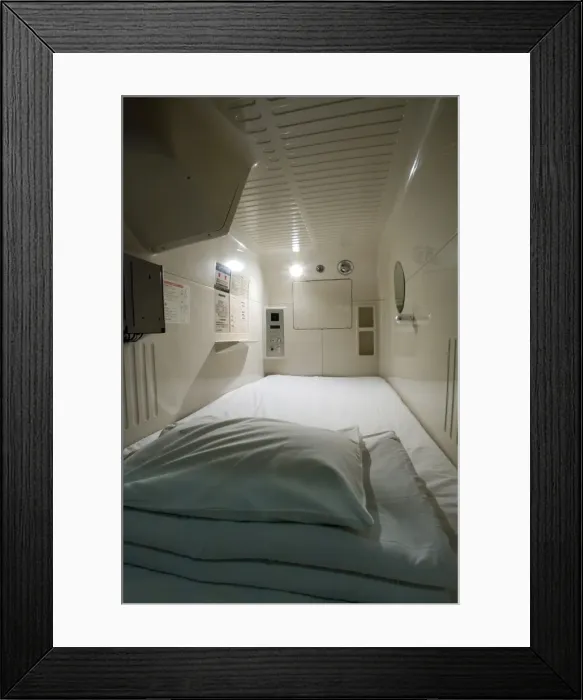 Framed Print : Interior view of single-person sleeping compartment at capsule hotel in Osaka Framed Print : Interior view of single-person sleeping compartment at capsule hotel in Osaka