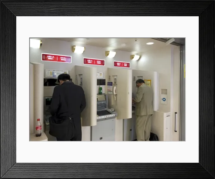 Framed Print : People doing after-hours banking at bank teller machines in Japan, Asia Framed Print : People doing after-hours banking at bank teller machines in Japan, Asia