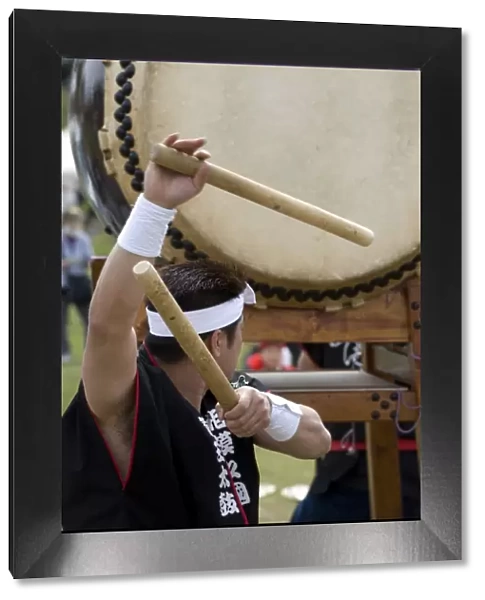 Drummer performing on a Japanese taiko drum at a festival in Kanagawa, Japan, Asia