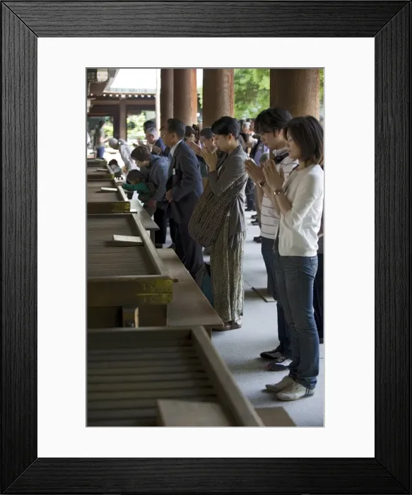 Framed Print : Worshippers praying in front of offertory boxes at main hall of Meiji Jingu shrine in Tokyo
