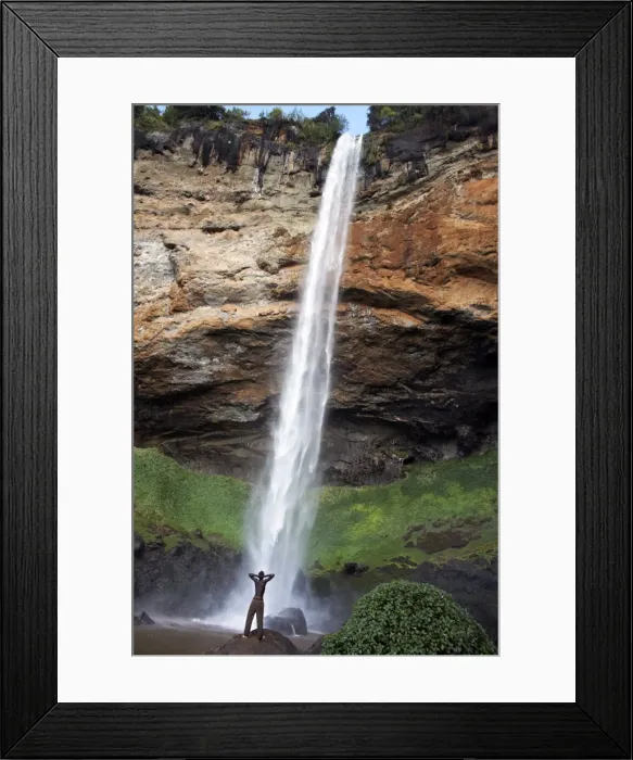 Framed Print : A man looks up at Sipi Falls, Uganda, East Africa, Africa Framed Print : A man looks up at Sipi Falls, Uganda, East Africa, Africa