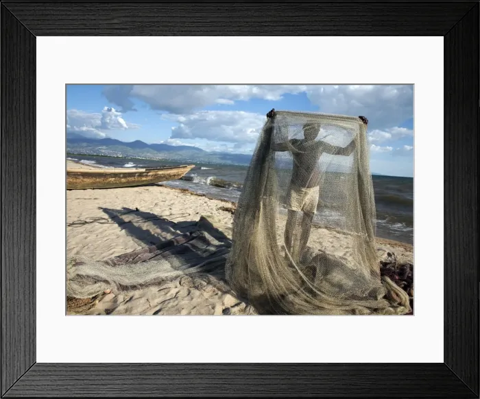 Framed Print : A fisherman tends his nets on Plage des Cocotiers (Coconut Beach) also known as Saga Beach Framed Print : A fisherman tends his nets on Plage des Cocotiers (Coconut Beach) also known as Saga Beach