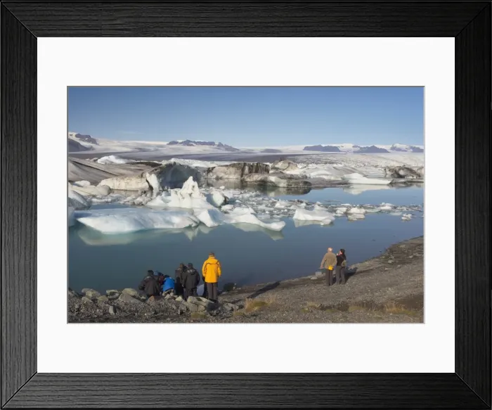 Framed Print : Tourists viewing icebergs in Jokulsarlon glacial lagoon, Oraefajokull glacier in the distance Framed Print : Tourists viewing icebergs in Jokulsarlon glacial lagoon, Oraefajokull glacier in the distance