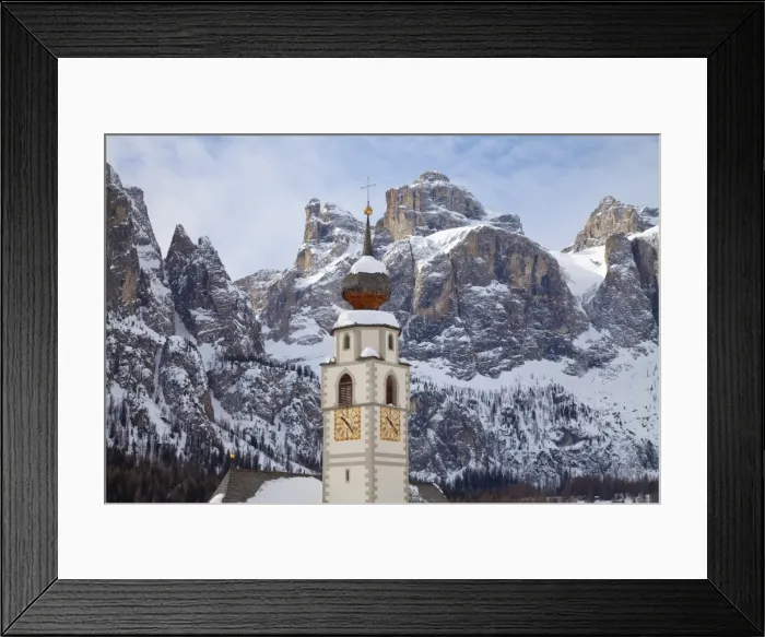 Framed Print : The church and village of Colfosco in Badia, 1645m, and Sella Massif range of mountains under winter snow, Dolomites, South Tirol, Trentino-Alto Adige